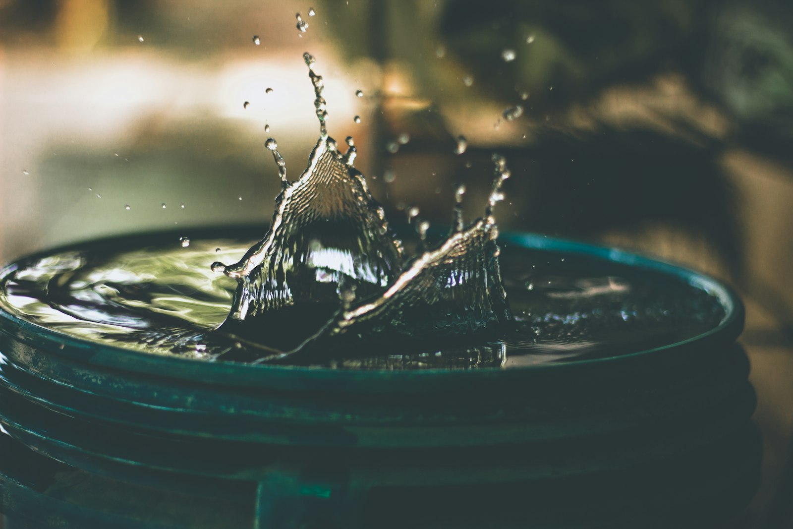 Water droplets splashing into a bucket